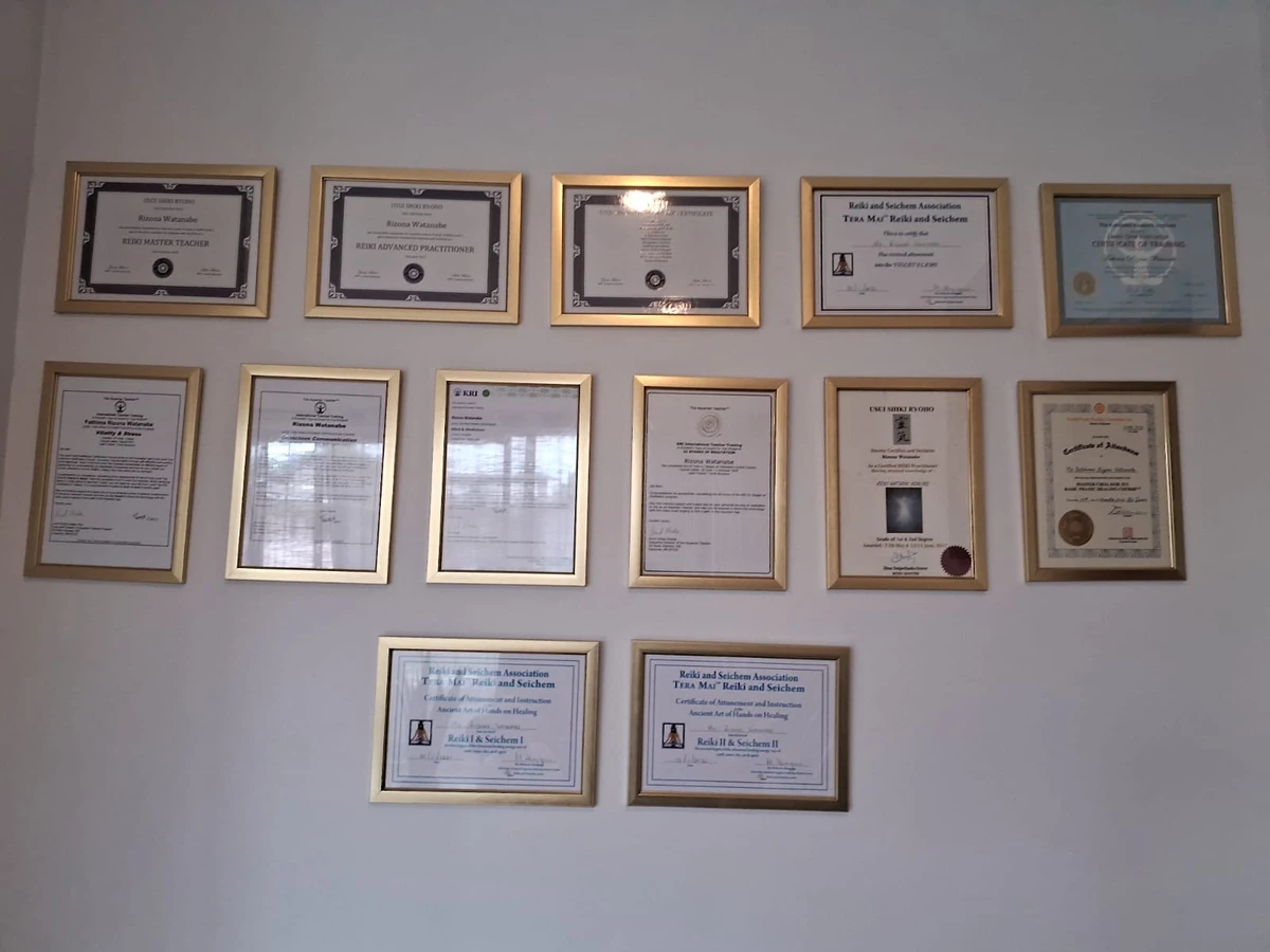 Rizona’s framed Reiki and Kundalini Yoga certificates displayed in the studio