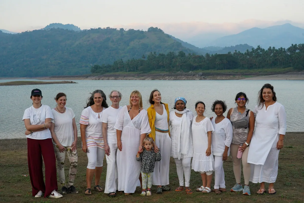 Participants from the Conscious Communication training gathered beside a lake