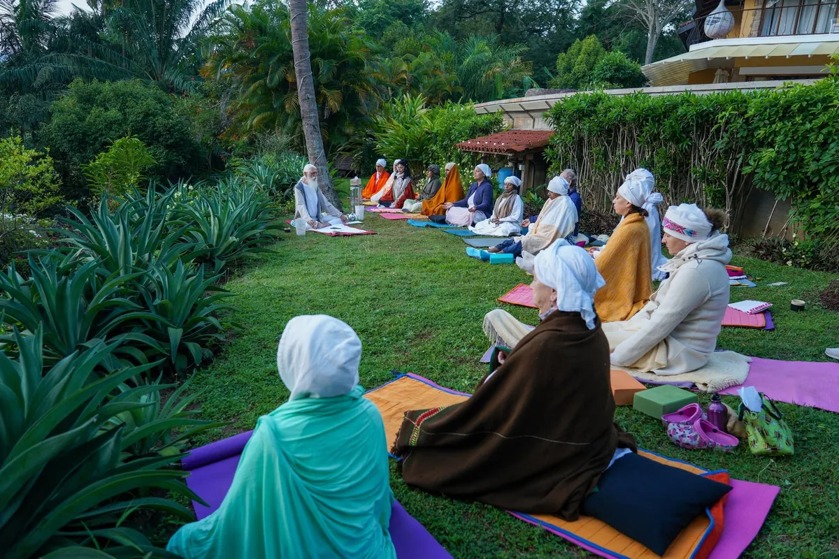 Participants sitting together for outdoor meditation during the Conscious Communication training